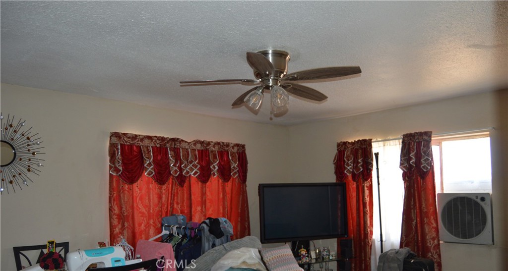 12065 Aztec Lane Adelanto, CA 92301 - Photo 35 of 64 a view of a bedroom with a window and a walk in closet