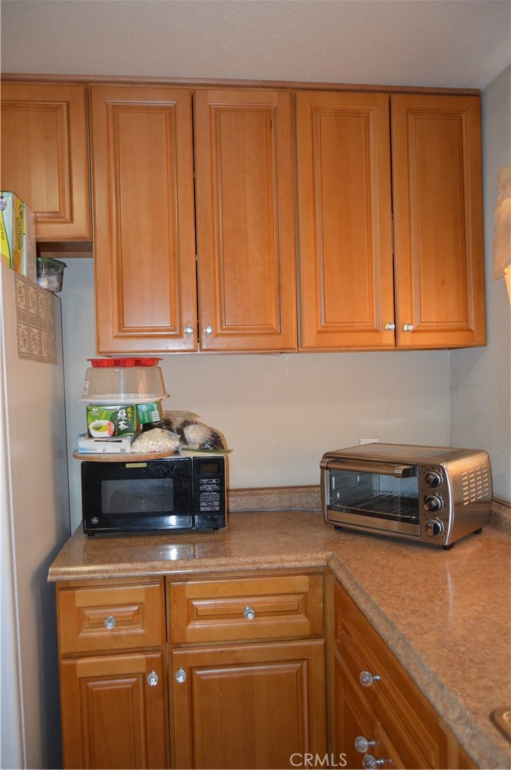 12065 Aztec Lane Adelanto, CA 92301 - Photo 49 of 64 a kitchen with stainless steel appliances granite countertop a refrigerator a stove a sink and dishwasher