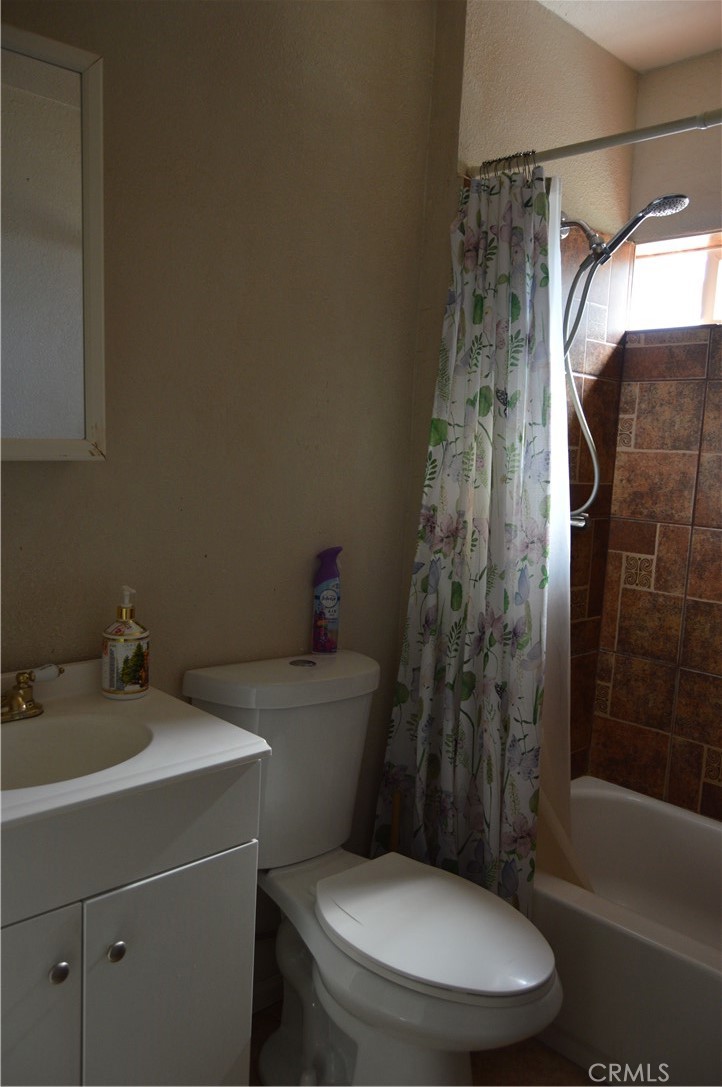 12065 Aztec Lane Adelanto, CA 92301 - Photo 57 of 64 a white toilet sitting next to a bathroom sink