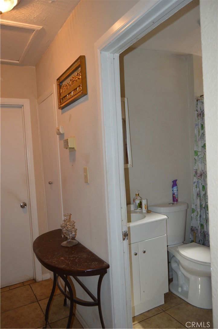 12065 Aztec Lane Adelanto, CA 92301 - Photo 58 of 64 a bathroom with a toilet a sink and a mirror