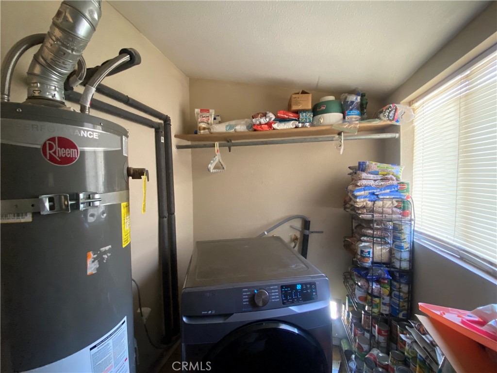 12065 Aztec Lane Adelanto, CA 92301 - Photo 62 of 64 a room with water heater and wooden floor