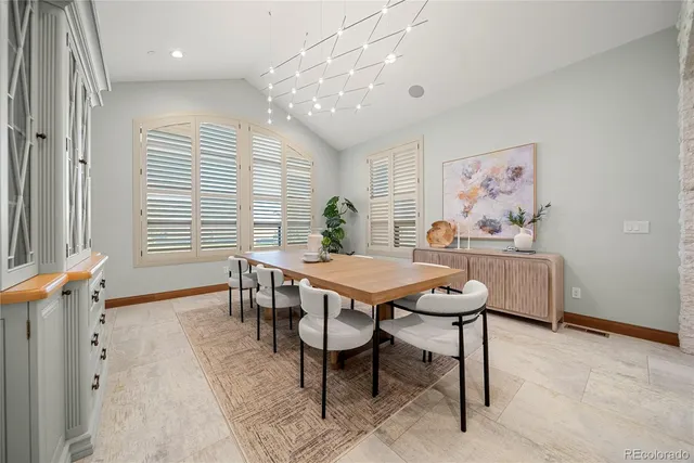 a dining room with a table and chairs
