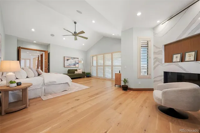 a bedroom with a bed large window and couch