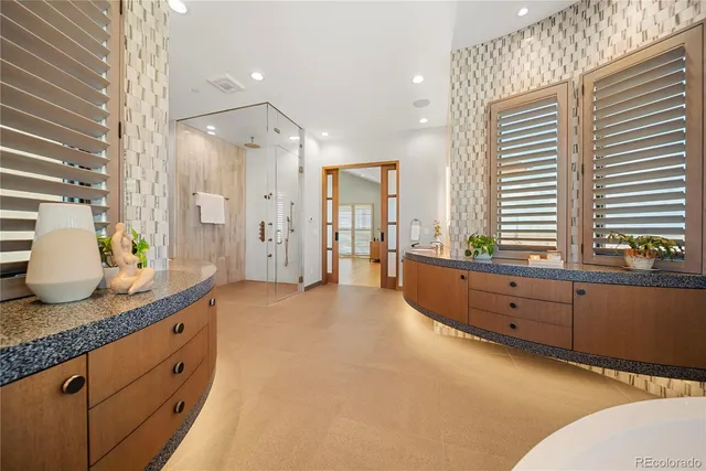a spacious bathroom with a granite countertop sink and a mirror