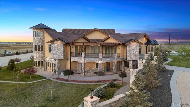 a front view of a house with a garden and plants