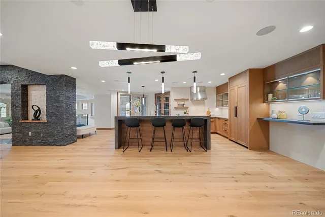 a view of a kitchen with kitchen island and stainless steel appliances