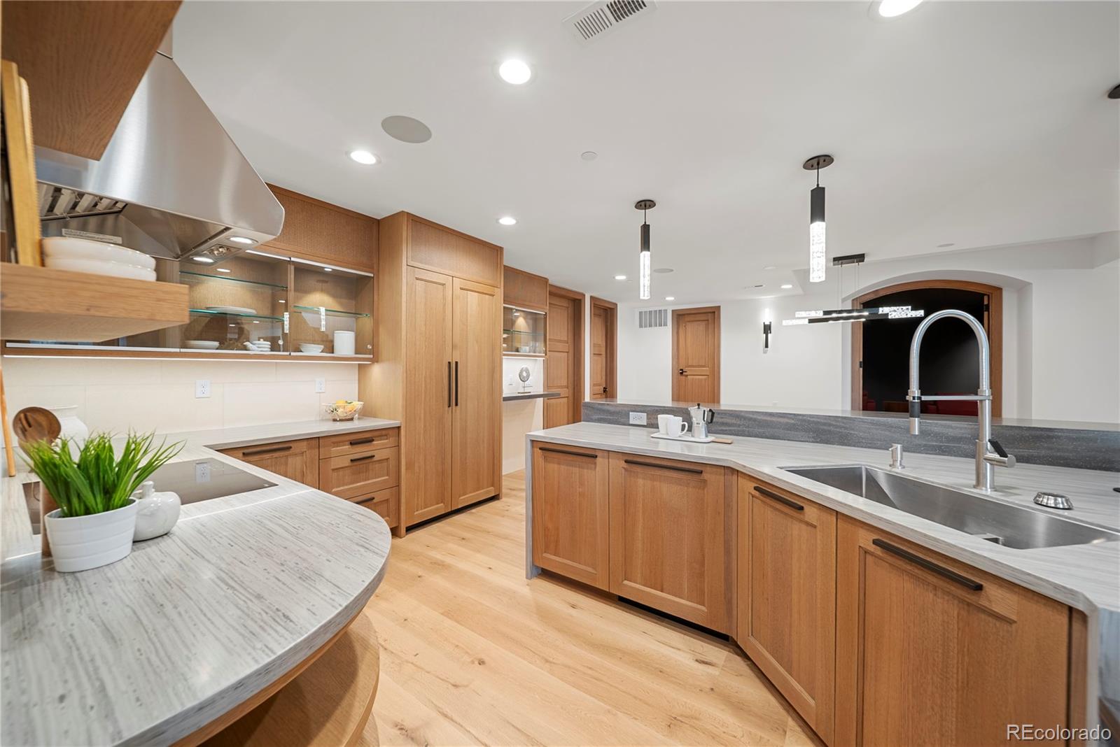 12565 Picadilly Road Commerce City, CO 80022 - Photo 37 of 50 a kitchen with stainless steel appliances granite countertop a sink a stove and a wooden floors