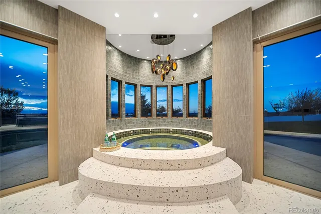 a view of a kitchen with kitchen island a large counter top space a sink stainless steel appliances and cabinets