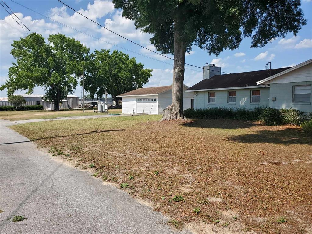2103 West Kelly Park Road Apopka, FL 32712 - Photo 15 of 24 a front view of a house with a yard and garage