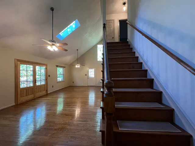 a view of entryway and hall with wooden floor
