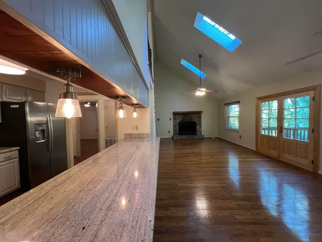 a view of a hallway with wooden floor