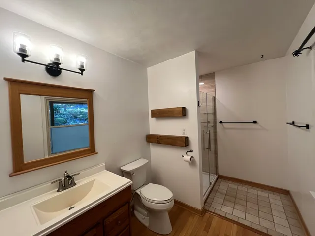 a bathroom with a sink toilet and shower