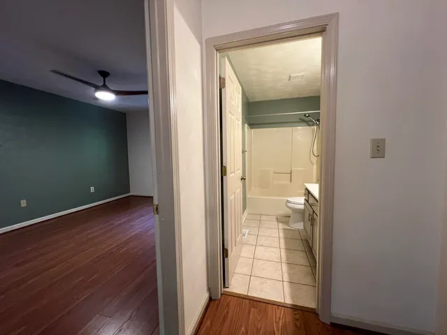 an empty room with wooden floor and a window