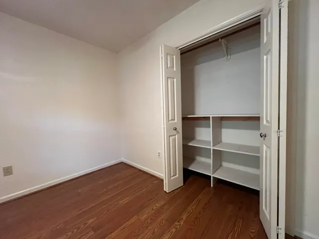 a view of a room with wooden floor