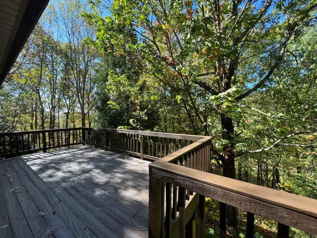a view of balcony with wooden floor and fence