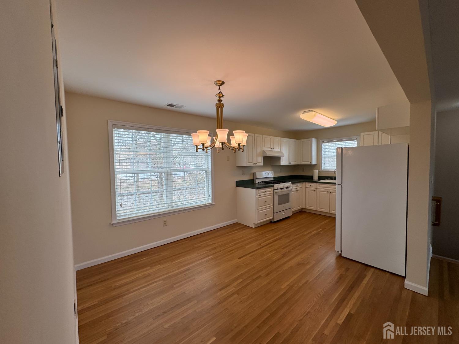 566 Cliff Road, Unit C Sewaren, NJ 07077 - Photo 6 of 14 a view of kitchen with granite countertop cabinets and refrigerator