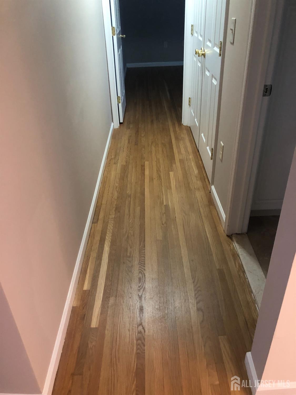 566 Cliff Road, Unit C Sewaren, NJ 07077 - Photo 8 of 14 a view of a hallway with wooden floor