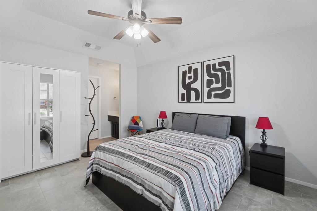 9780 Windy Ridge Road Frisco, TX 75033 - Photo 12 of 25 Bright room featuring light gray walls, a sloped ceiling, and wood-finish ceiling fan