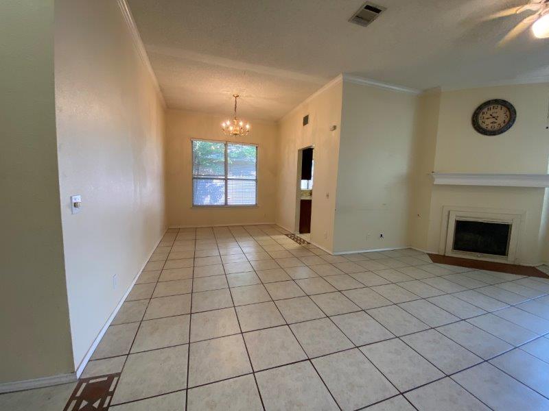 1903 Balsam Way Round Rock, TX 78665 - Photo 5 of 21 A spacious room presents a fireplace and tiled floors, ready for personal touches.
