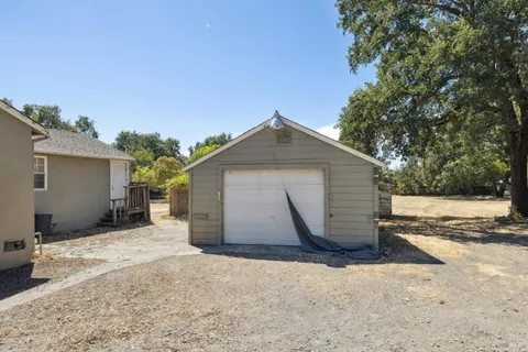 a view of a house with a yard and garage