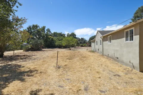 a backyard of a house with large trees