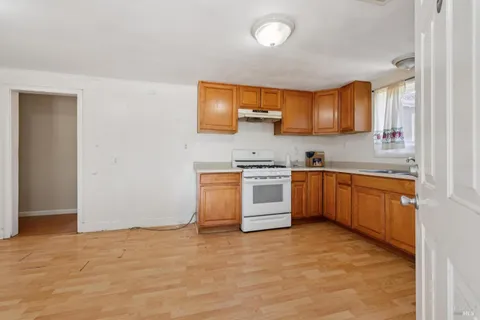 a kitchen with stainless steel appliances granite countertop a stove sink and cabinets