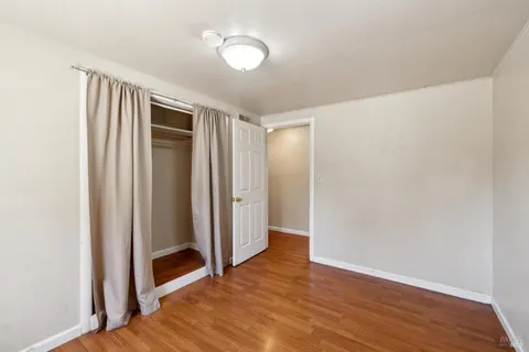 a view of hallway with wooden floor