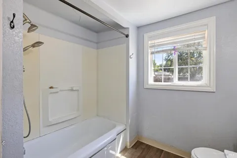 a bathroom with a window and a shower