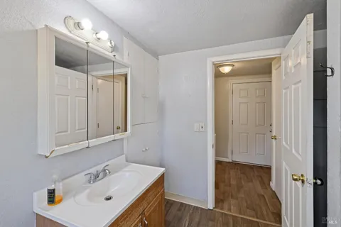 a bathroom with a sink a mirror and shower
