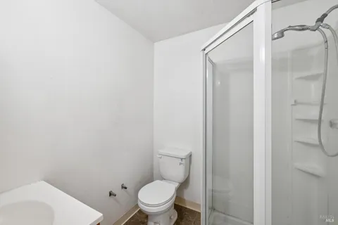 a white toilet sitting next to a bathroom sink