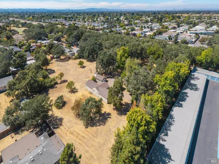 an aerial view of a house with a yard