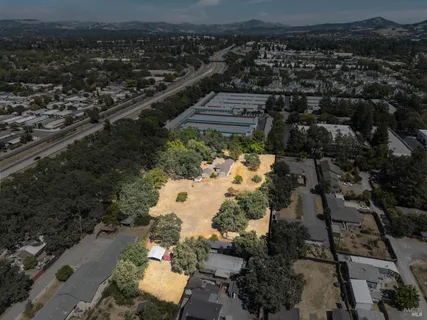 an aerial view of a house with a yard