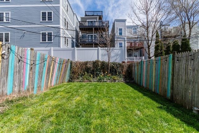 a view of backyard with barbeque oven and trees