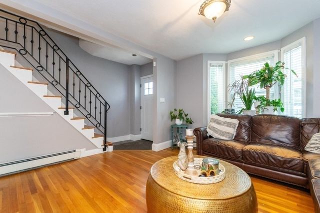 a living room with furniture and a dining table