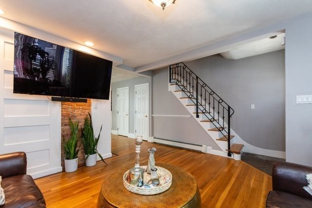 a view of a livingroom with furniture and hardwood floor