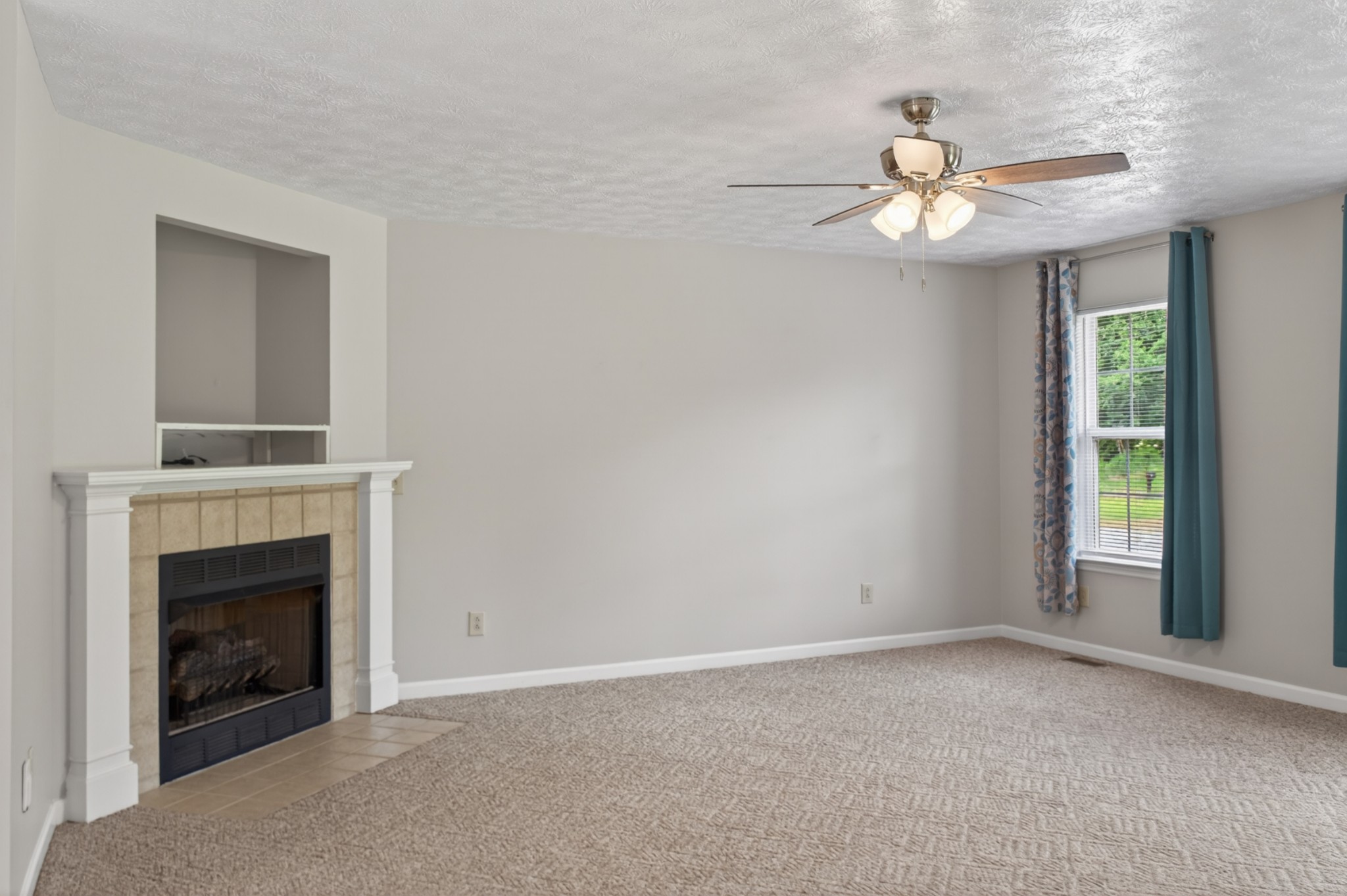 618 Lear Road Portland, TN 37148 - Photo 9 of 29 a view of an empty room with chandelier fan and fire place