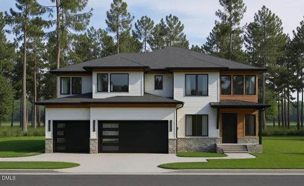 a front view of a house with a yard and trees
