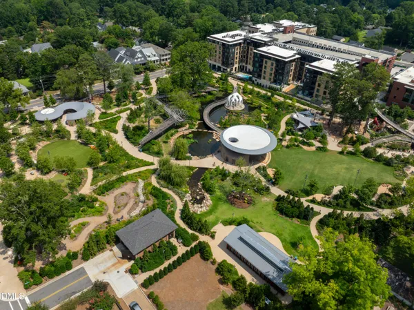 an aerial view of residential house with outdoor space and trees all around