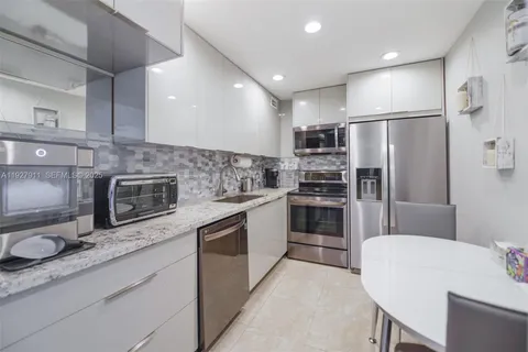 a kitchen with stainless steel appliances a refrigerator and a stove top oven