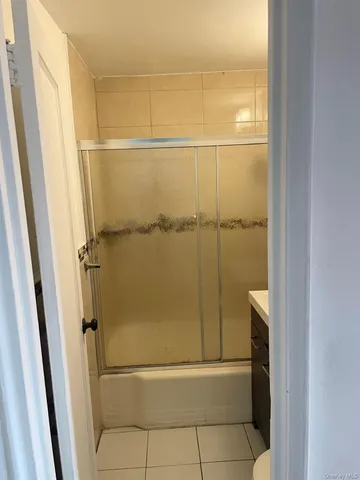 a bathroom with a glass shower door
