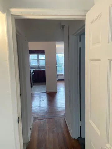 a view of a hallway view with wooden floor and staircase