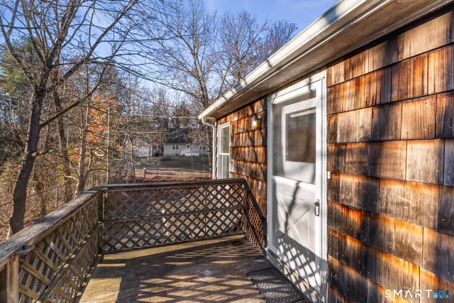 a view of balcony with wooden floor and fence