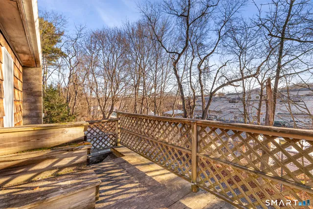 a view of balcony with wooden floor and fence