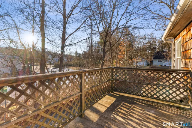 a view of wooden balcony with trees