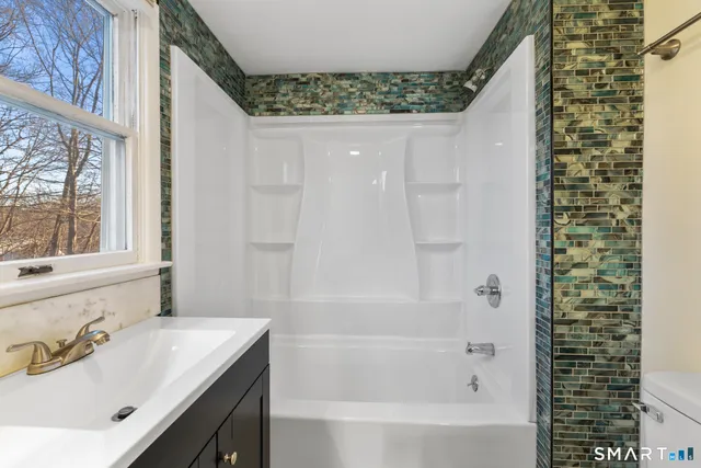 a bathroom with a bathtub and a sink