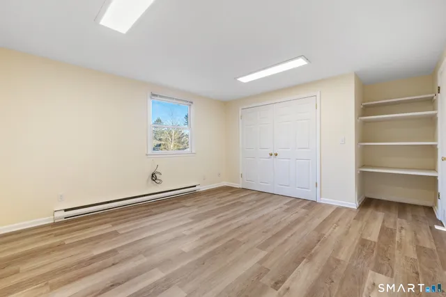 a view of an empty room and a window