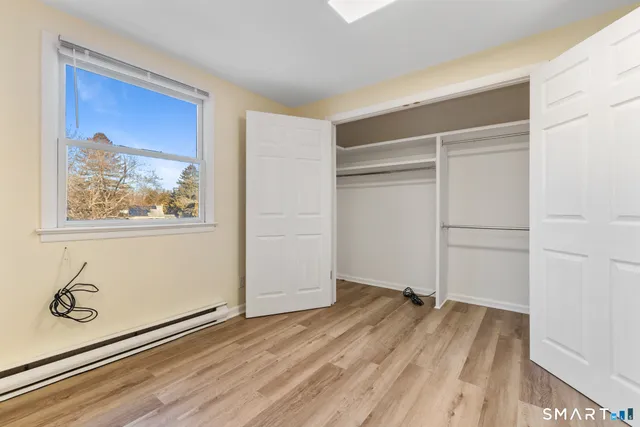 a view of a room with wooden floor