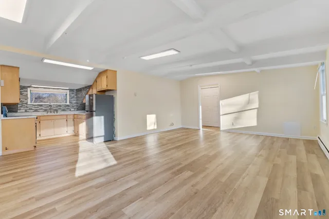 a view of a kitchen with cabinets and wooden floor