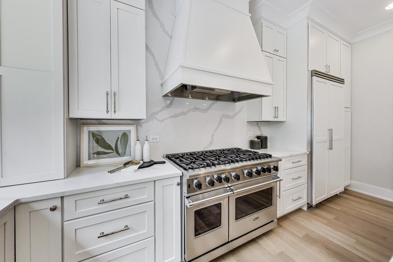 405 Ridge Avenue Clarendon Hills, IL 60514 - Photo 6 of 17 a kitchen with stainless steel appliances white cabinets and a stove a oven with wooden floors