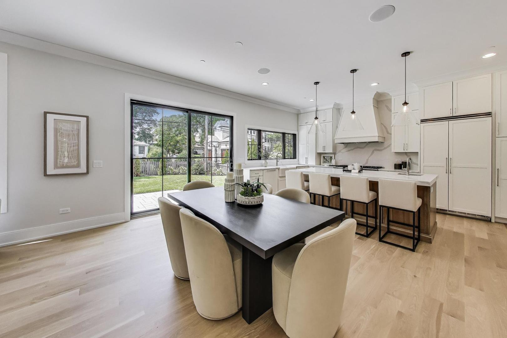 405 Ridge Avenue Clarendon Hills, IL 60514 - Photo 9 of 17 a living room with stainless steel appliances granite countertop furniture a couch a large window and a refrigerator